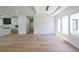 Open concept living space with light wood floors, modern lighting, large windows, and decorative wall at 972 Auburn Rd, Dacula, GA 30019