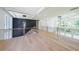 Bright loft area featuring hardwood floors, modern lighting fixtures and black accent wall at 972 Auburn Rd, Dacula, GA 30019
