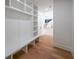 Bright mudroom features custom built-in storage, bench seating, and hardwood floors leading to the main house at 972 Auburn Rd, Dacula, GA 30019
