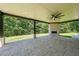 Covered patio with stone fireplace and ceiling fan, ideal for outdoor entertaining at 972 Auburn Rd, Dacula, GA 30019