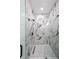 Modern shower showcasing stunning marble tile and sleek glass enclosure at 972 Auburn Rd, Dacula, GA 30019