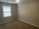 Cozy bedroom with neutral carpet and natural light from a window at 1075 Crystal Water Dr, Lawrenceville, GA 30045