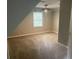 Bright bedroom with neutral carpet, ceiling fan and natural light from a window at 1075 Crystal Water Dr, Lawrenceville, GA 30045