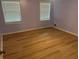 Bright bedroom with hardwood floors and natural light from two windows at 1075 Crystal Water Dr, Lawrenceville, GA 30045