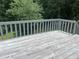 Exterior view of a wooden deck and railing with wooded backyard at 1075 Crystal Water Dr, Lawrenceville, GA 30045