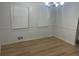 Bright dining room with vinyl floors, a chandelier, and neutral wall colors at 1075 Crystal Water Dr, Lawrenceville, GA 30045