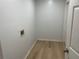 A dedicated laundry room with vinyl floors and connections ready for washer/dryer hookup at 1075 Crystal Water Dr, Lawrenceville, GA 30045