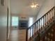 Inviting living room with a stone fireplace, wood floors, ceiling fan, and natural light at 1075 Crystal Water Dr, Lawrenceville, GA 30045