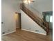 A bright living room showcasing vinyl floors, wood stairs, and a ceiling fan at 1075 Crystal Water Dr, Lawrenceville, GA 30045