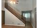 Living room features a staircase, natural light, and a view of the front entrance at 1075 Crystal Water Dr, Lawrenceville, GA 30045