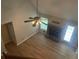 Open living room with hardwood floors, fireplace and large ceiling fan at 1075 Crystal Water Dr, Lawrenceville, GA 30045