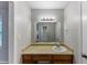 Bathroom featuring granite countertop, wood cabinets, and vanity mirror at 1296 Carman Se Ct, Conyers, GA 30013