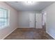 Bedroom featuring neutral carpet, closet, and window with blinds at 1296 Carman Se Ct, Conyers, GA 30013