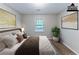 Virtually staged bedroom with bed, plant, and artwork at 1296 Carman Se Ct, Conyers, GA 30013