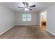 Spacious bedroom featuring neutral paint, carpet flooring, ceiling fan and natural light at 1296 Carman Se Ct, Conyers, GA 30013