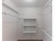 This is a closet with white walls, shelves and carpet flooring at 1296 Carman Se Ct, Conyers, GA 30013