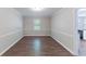 Dining room with wood-look floors, chair rail, and a bright window at 1296 Carman Se Ct, Conyers, GA 30013