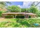 Charming brick ranch-style home with mature trees and well-manicured landscaping at 1296 Carman Se Ct, Conyers, GA 30013