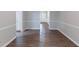 Hallway leading to the front door with wood-look floors and wainscoting at 1296 Carman Se Ct, Conyers, GA 30013