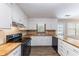 Kitchen with butcher block countertops and stainless steel appliances at 1296 Carman Se Ct, Conyers, GA 30013