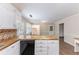 Kitchen with white cabinets, butcher block counters and view to laundry room at 1296 Carman Se Ct, Conyers, GA 30013