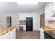 Bright kitchen featuring white cabinets, butcher block countertops and black refrigerator at 1296 Carman Se Ct, Conyers, GA 30013