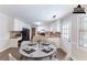 Staged kitchen with white cabinets, wood counters and table at 1296 Carman Se Ct, Conyers, GA 30013