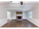 Living room featuring fireplace, built-in bookshelves, and wood floors at 1296 Carman Se Ct, Conyers, GA 30013