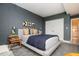 Bedroom featuring a bed, textured gray walls, and a door leading to another room at 145 15Th Ne St # 1225, Atlanta, GA 30309