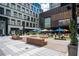 Inviting courtyard with colorful umbrellas, ample seating, and lush greenery in a vibrant mixed-use development at 145 15Th Ne St # 1225, Atlanta, GA 30309