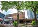 Picturesque exterior view of a food hall and entertainment complex, nestled among lush greenery and city skylines at 145 15Th Ne St # 1225, Atlanta, GA 30309