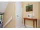 Hallway with simple staircase, complemented by a charming wooden console table and elegant artwork at 145 15Th Ne St # 1225, Atlanta, GA 30309