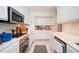 Bright white kitchen featuring stainless steel appliances, mosaic backsplash, and ample counter space at 145 15Th Ne St # 1225, Atlanta, GA 30309