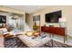 Open living space with a rustic coffee table, flat screen TV, and mirrored wall reflecting the outdoors at 145 15Th Ne St # 1225, Atlanta, GA 30309