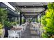 Charming outdoor dining area with stylish tables, chairs, ambient lighting, and lush greenery at 145 15Th Ne St # 1225, Atlanta, GA 30309