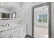 Modern bathroom with double vanity, designer mirror, and access to bedroom at 3378 Bachelor St, Atlanta, GA 30344