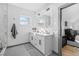 Bright bathroom with double sink vanity, white cabinets and a glass door shower at 3378 Bachelor St, Atlanta, GA 30344