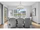 Elegant dining room with modern chandelier, neutral color scheme, and large window offering ample natural light at 3378 Bachelor St, Atlanta, GA 30344