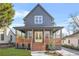 Charming two-story home features a welcoming front porch, manicured lawn, and a modern gray exterior at 3378 Bachelor St, Atlanta, GA 30344