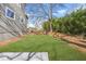 View of the property's landscaped side yard offering ample outdoor space and mature shrubbery at 3378 Bachelor St, Atlanta, GA 30344