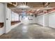 Unfinished basement space with exposed pipes, concrete floor, and painted brick at 650 Glen Iris Drive Ne # 27, Atlanta, GA 30308