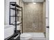 Modern bathroom with frameless glass shower, tiled walls, and sleek black shelving at 650 Glen Iris Drive Ne # 27, Atlanta, GA 30308