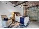 Cozy bedroom with exposed brick, barn door accent, and modern furnishings at 650 Glen Iris Drive Ne # 27, Atlanta, GA 30308