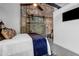 Relaxing bedroom featuring exposed brick, sliding barn door and a cozy bed at 650 Glen Iris Drive Ne # 27, Atlanta, GA 30308