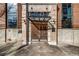 Stately stone and brick building entrance featuring wood doors and transom with industrial details at 650 Glen Iris Drive Ne # 27, Atlanta, GA 30308