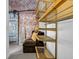Spacious walk-in closet with a seating area, exposed brick and custom adjustable metal shelving units at 650 Glen Iris Drive Ne # 27, Atlanta, GA 30308