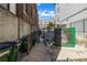 Exterior view of alley with trash bins and metal gated entrance to building at 650 Glen Iris Drive Ne # 27, Atlanta, GA 30308