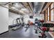 This home gym includes a treadmill, elliptical, weights, and mounted television at 650 Glen Iris Drive Ne # 27, Atlanta, GA 30308