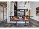 Modern kitchen with black island and bar seating, stainless steel appliances, and exposed concrete beams at 650 Glen Iris Drive Ne # 27, Atlanta, GA 30308