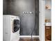 Efficient laundry room featuring a sleek washer and dryer with modern fixtures and lighting at 650 Glen Iris Drive Ne # 27, Atlanta, GA 30308